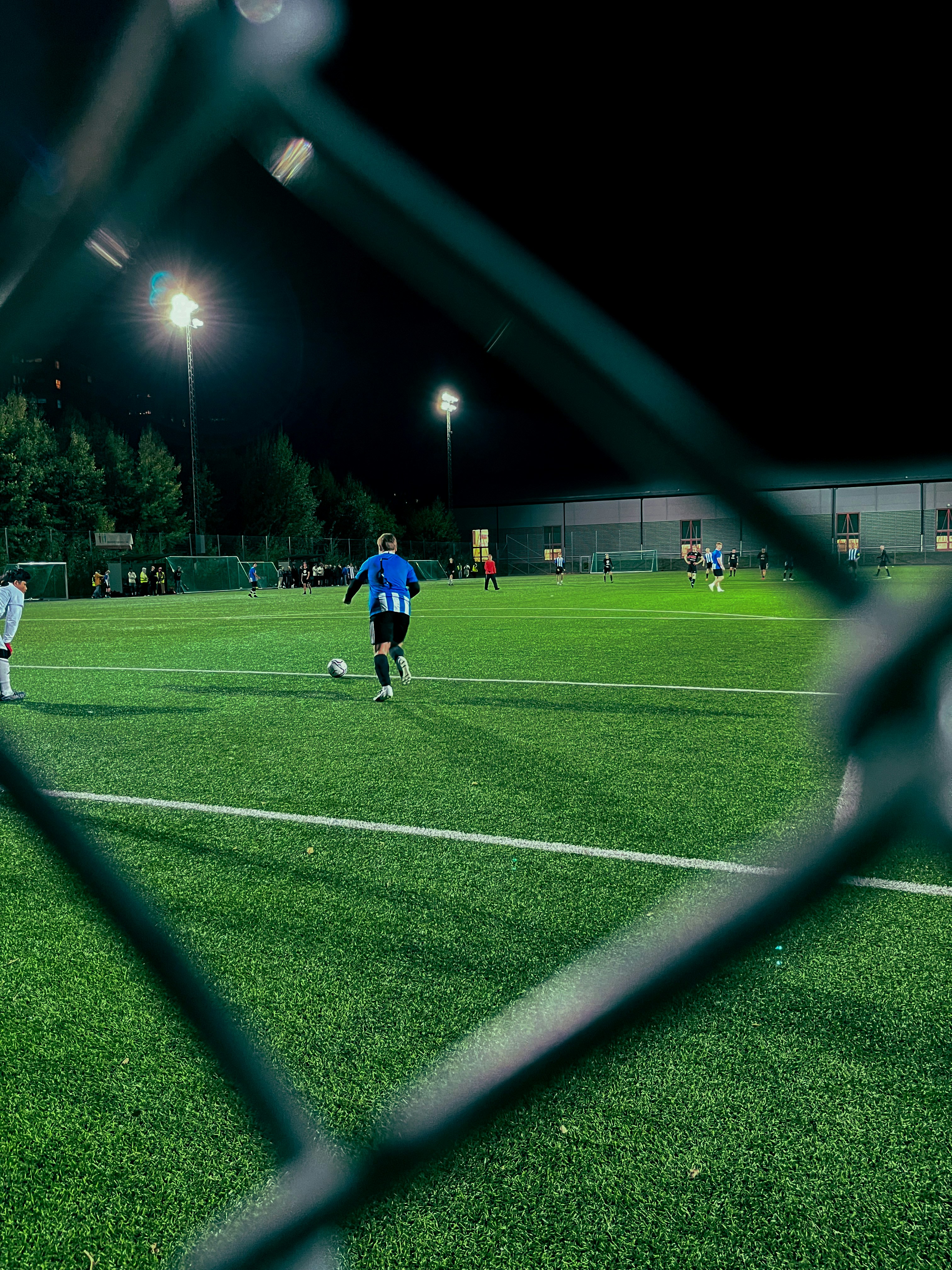 Synthetic grass installation with sports players running on it