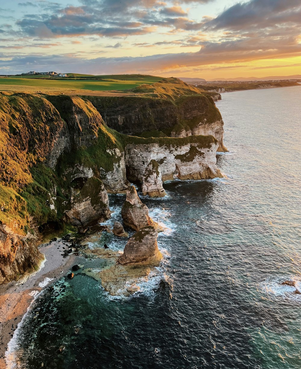 a cliff with a body of water below