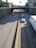 A busy highway with multiple trucks driving swiftly under a clear sky.