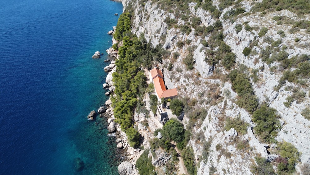 a building on a cliff by the water