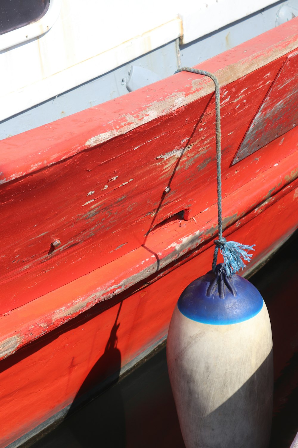 a vase sits in front of a red bench