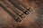 An elegant display of various belts arranged neatly on a wooden surface.