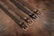An elegant display of various belts arranged neatly on a wooden surface.