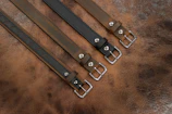 Judô belts stacked in order of rank, showcasing texture and stitching details.