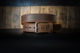 a leather belt on a black surface