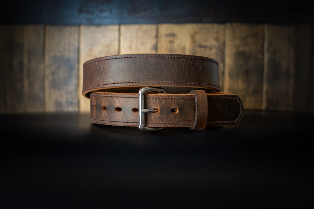 a leather belt on a black surface