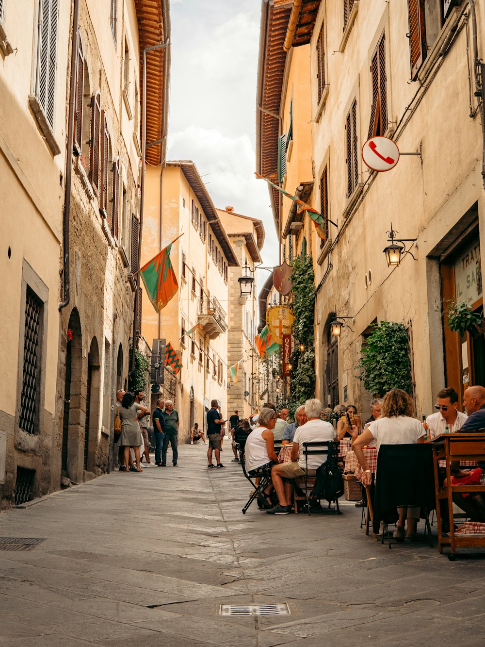 people sitting at tables in a street