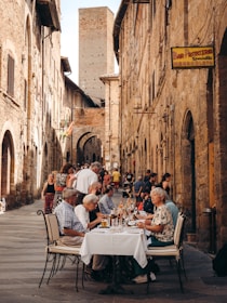 people sitting at a table outside in Italy