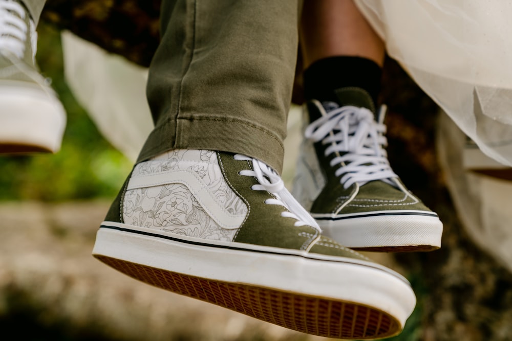 a pair of feet wearing white sneakers