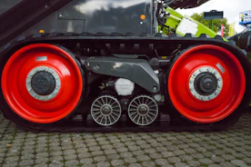 Close-up of heavy-duty construction machinery wheels on rough terrain
