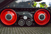 Close-up of a heavy vehicle equipped with tracking hardware under bright daylight.
