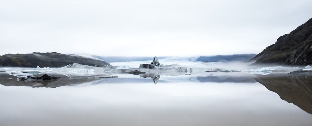 a group of jets flying over water