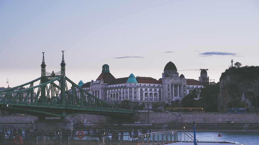 a bridge over water leading to a large building