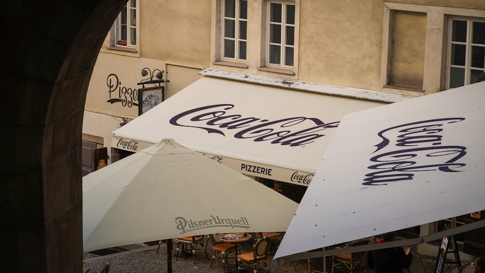 a white tent with a blue logo