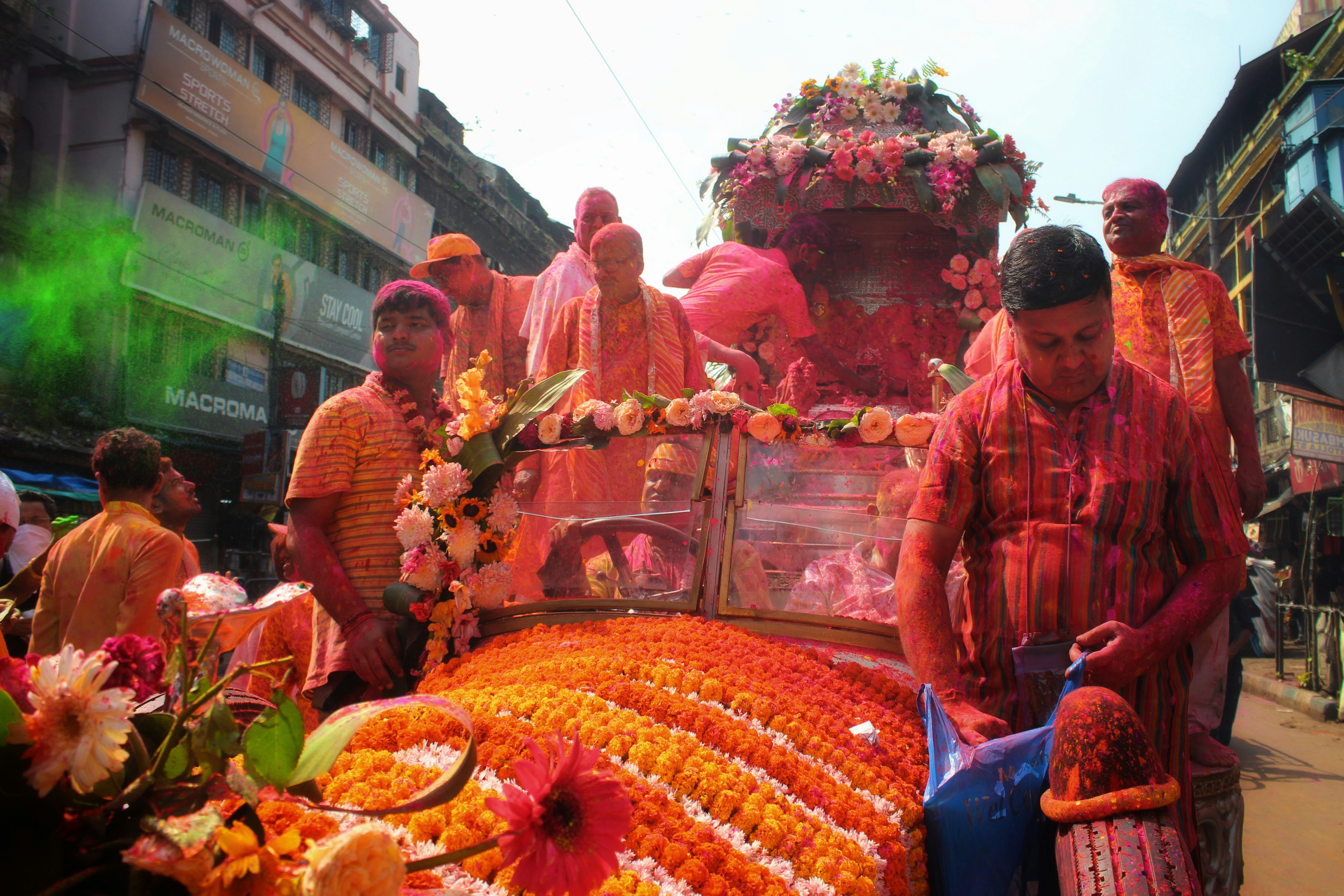 a group of people standing around a table full of flowers