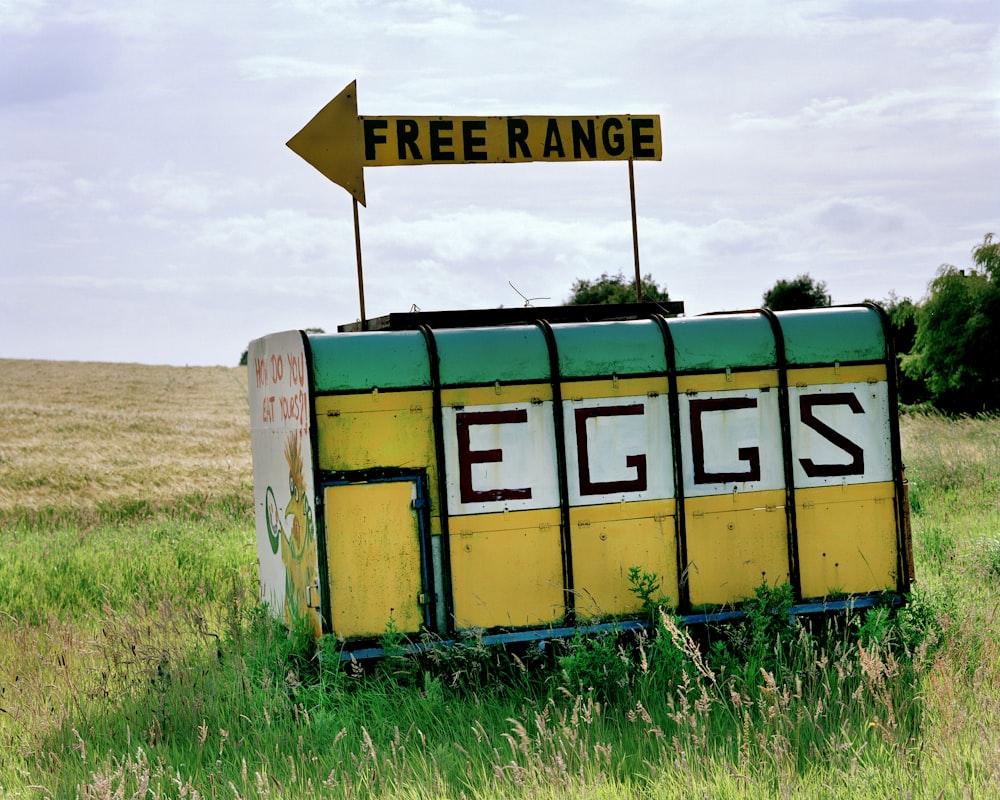 a yellow and white van with a sign on it