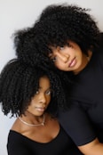 a woman with curly hair and a man with long hair