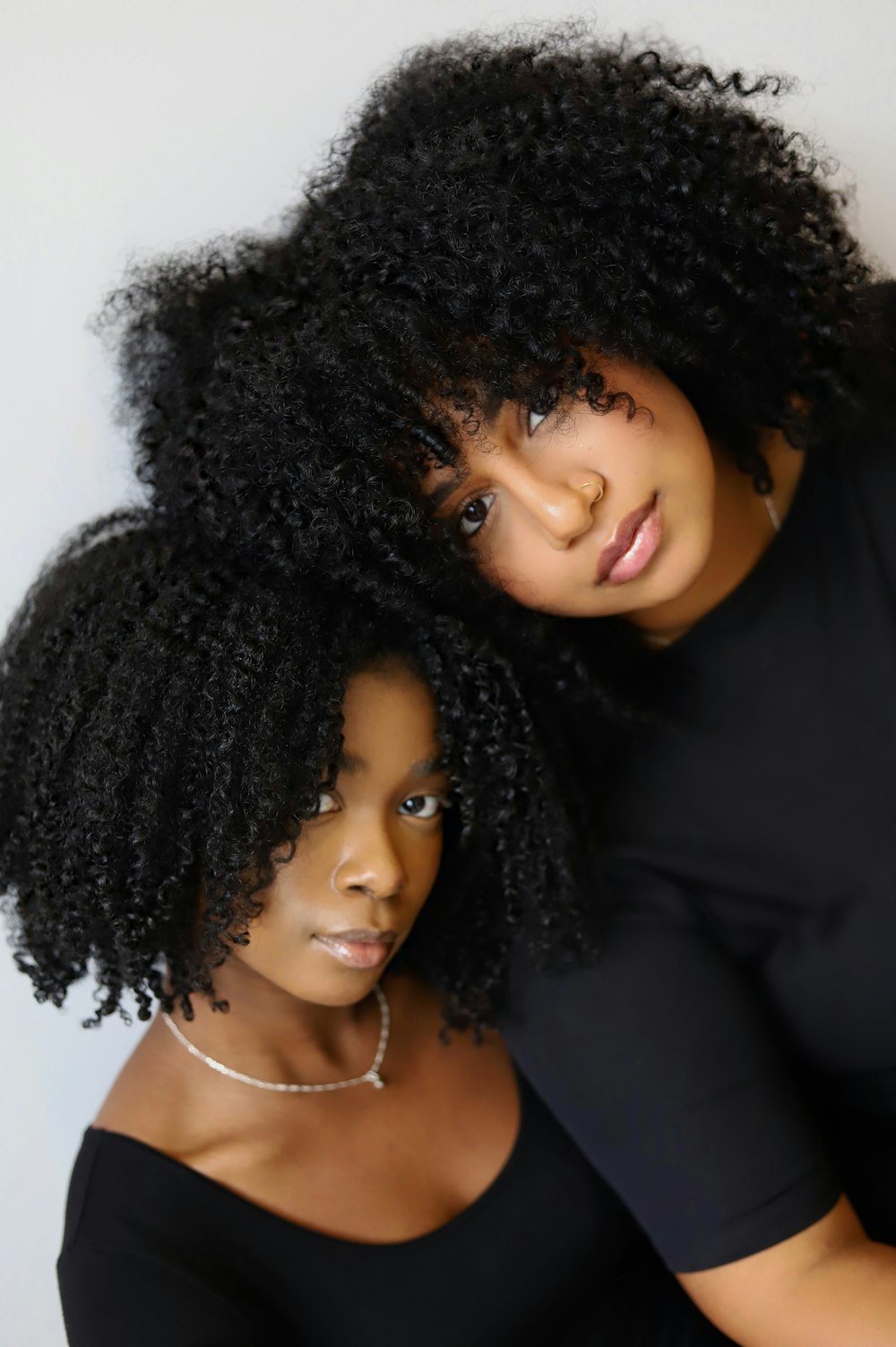 a woman with curly hair and a man with long hair