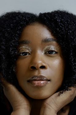 a woman with her hand on her face