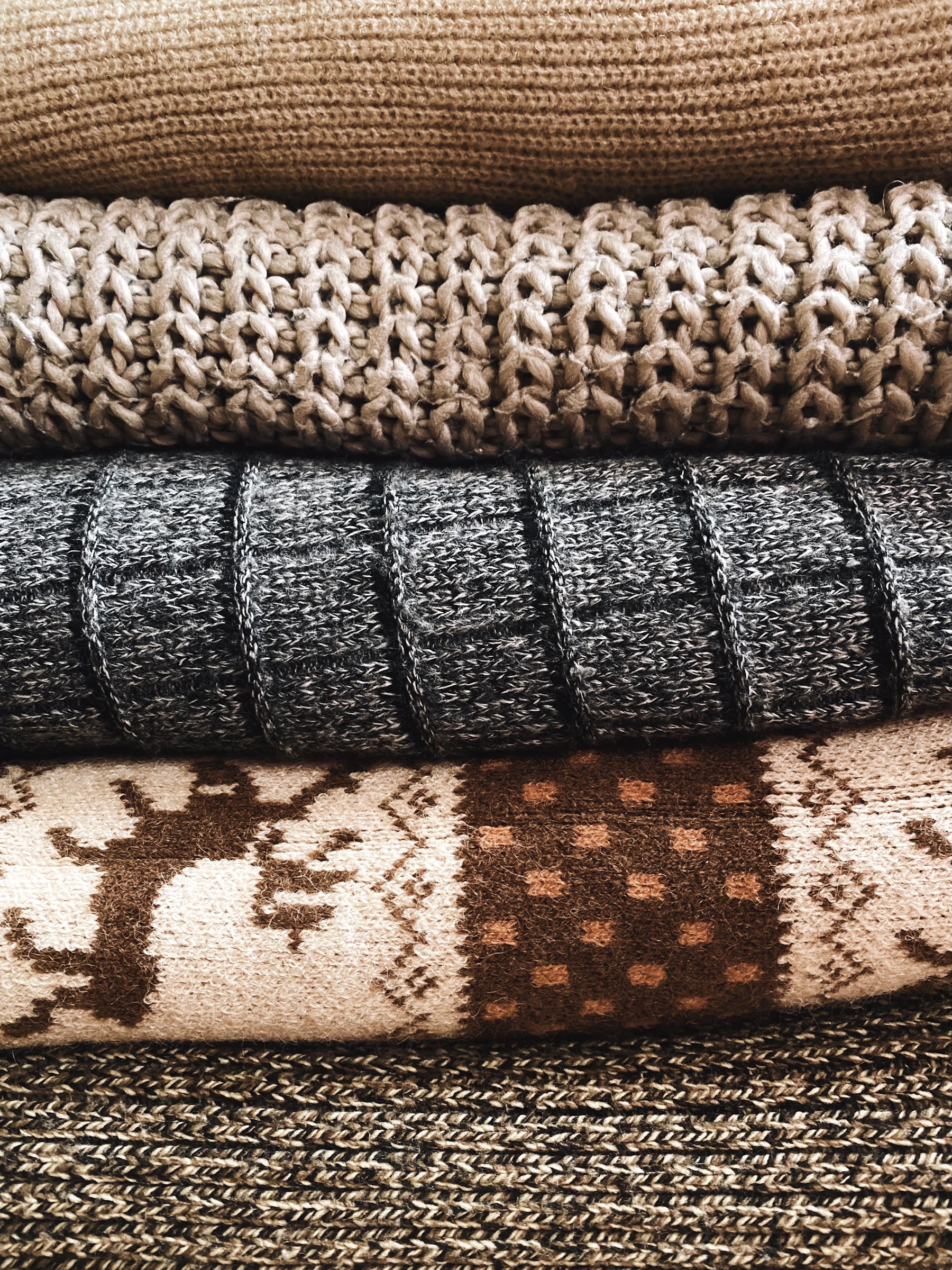 Close-up of layered knitted textiles showing fine fibre texture and different fabric structures