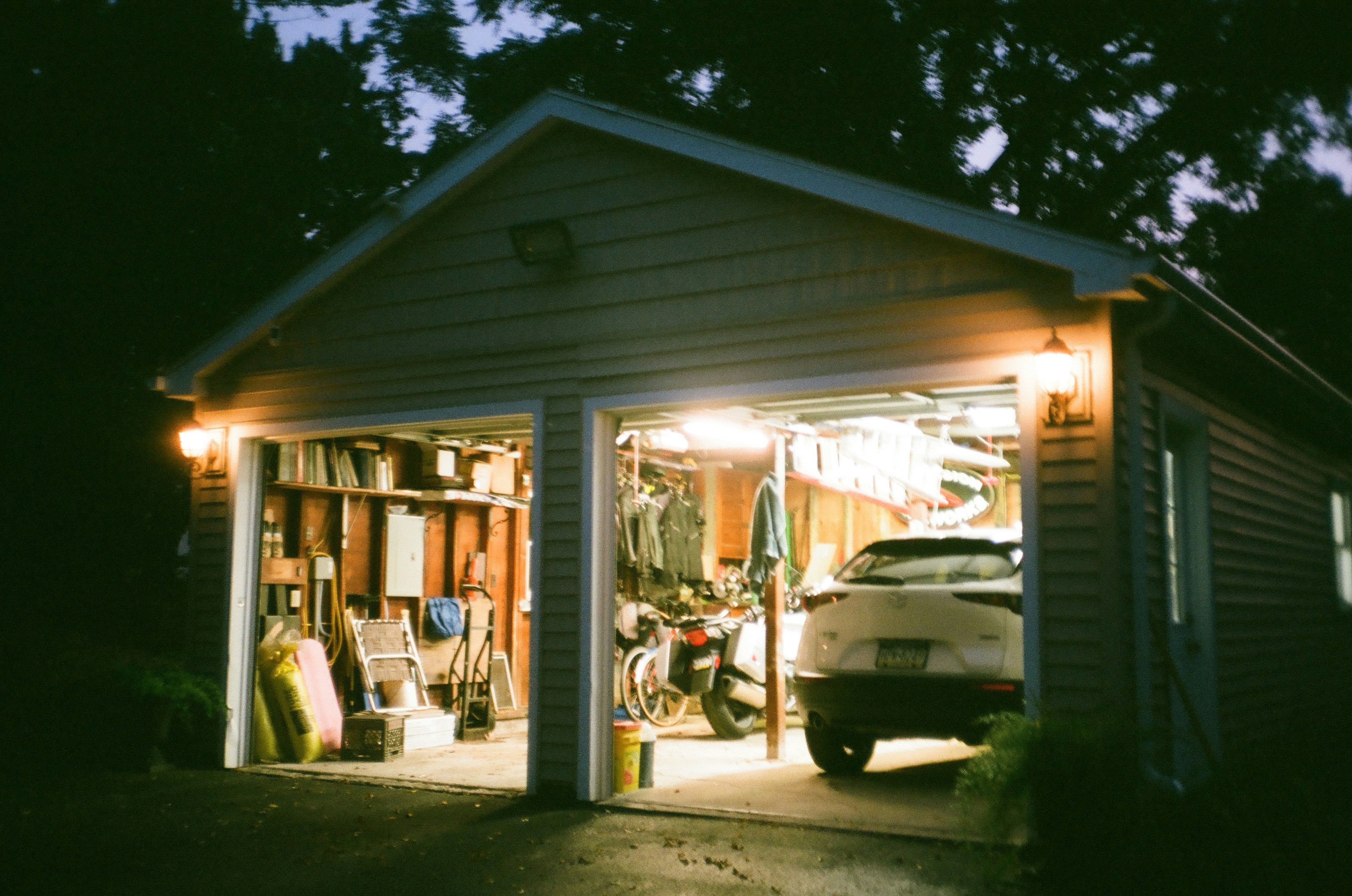 Family with a modern electric SUV plugged into a home charger in a garage