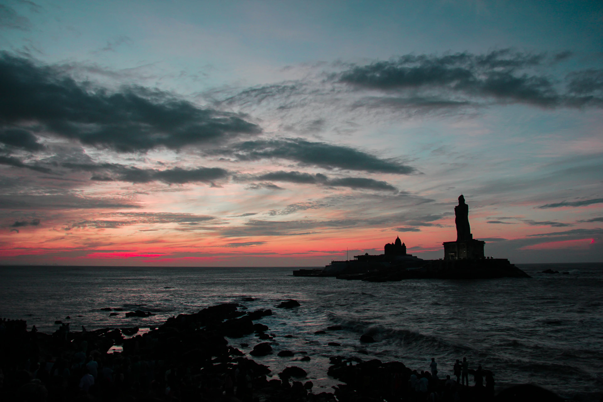 a statue on a rocky shore