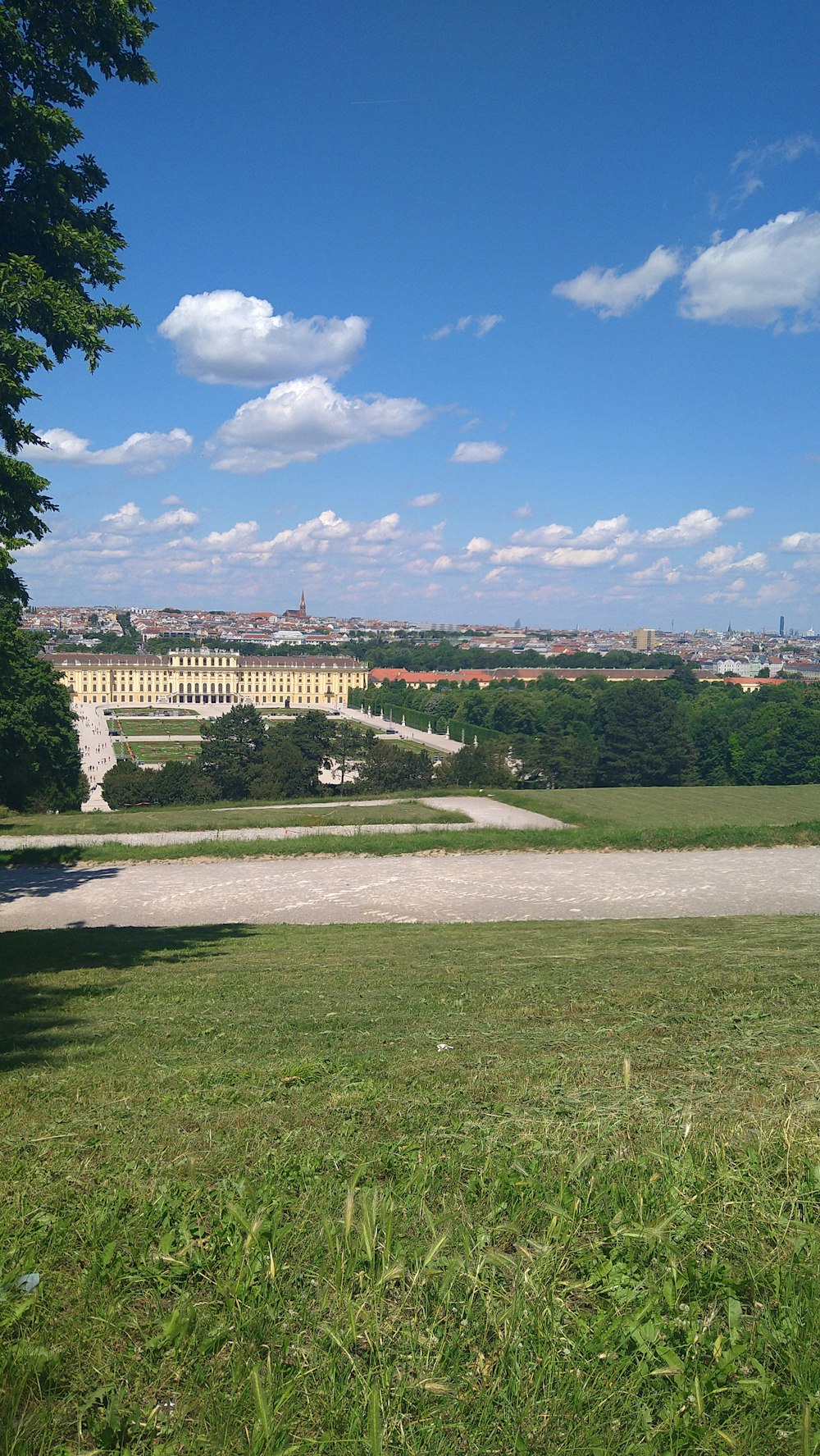 a large building with a field in front of it