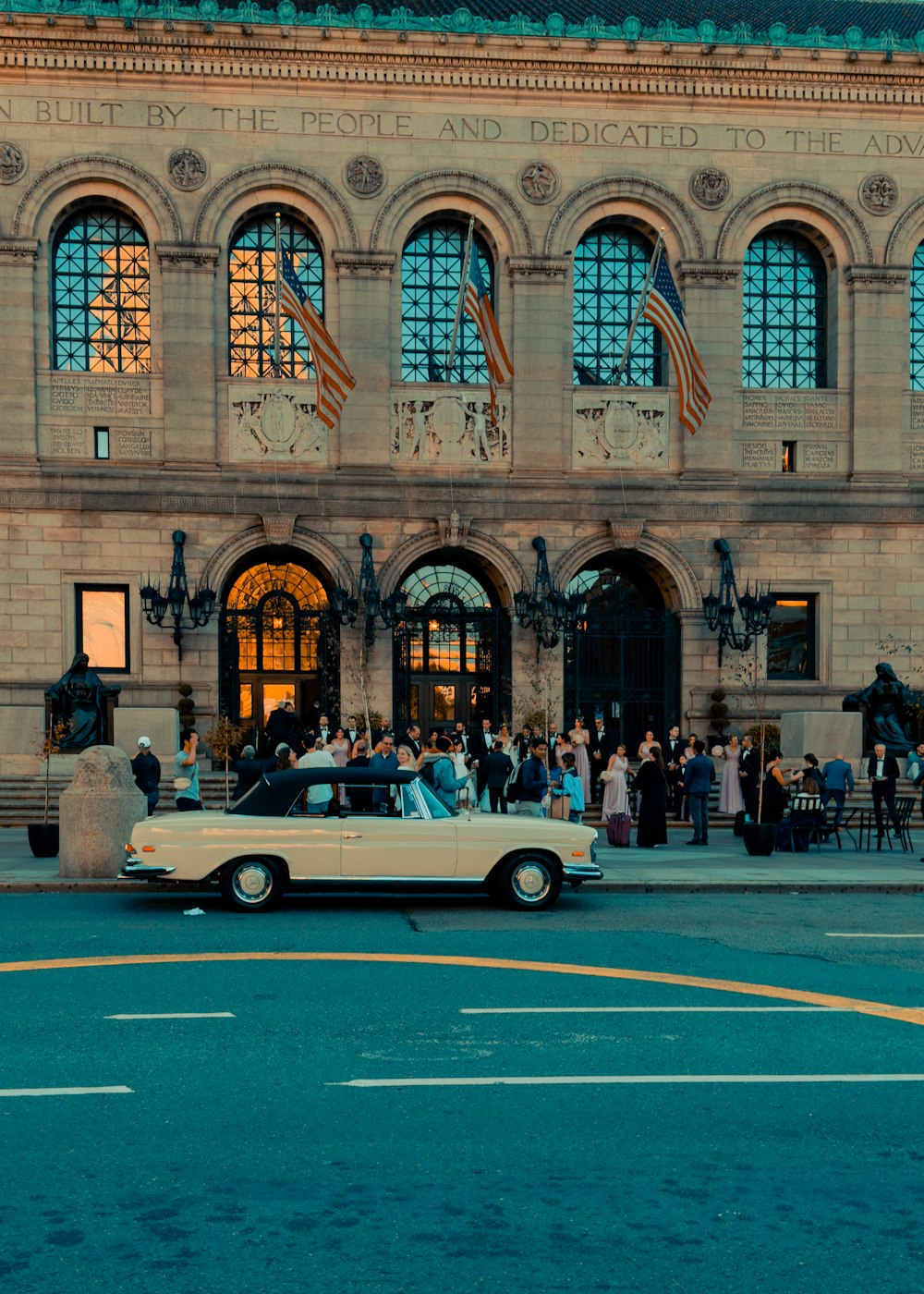 a car parked in front of a building with many windows