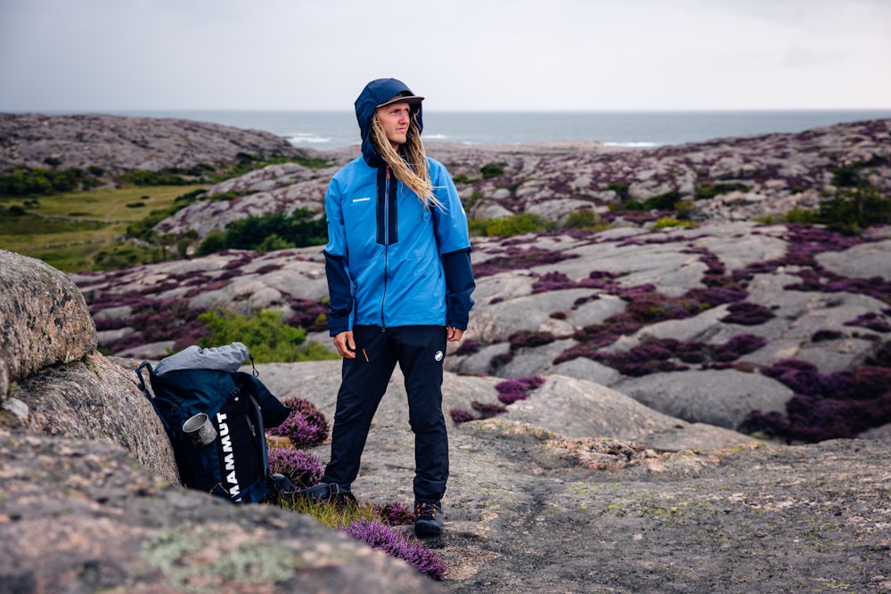 a person standing on a rocky hillside