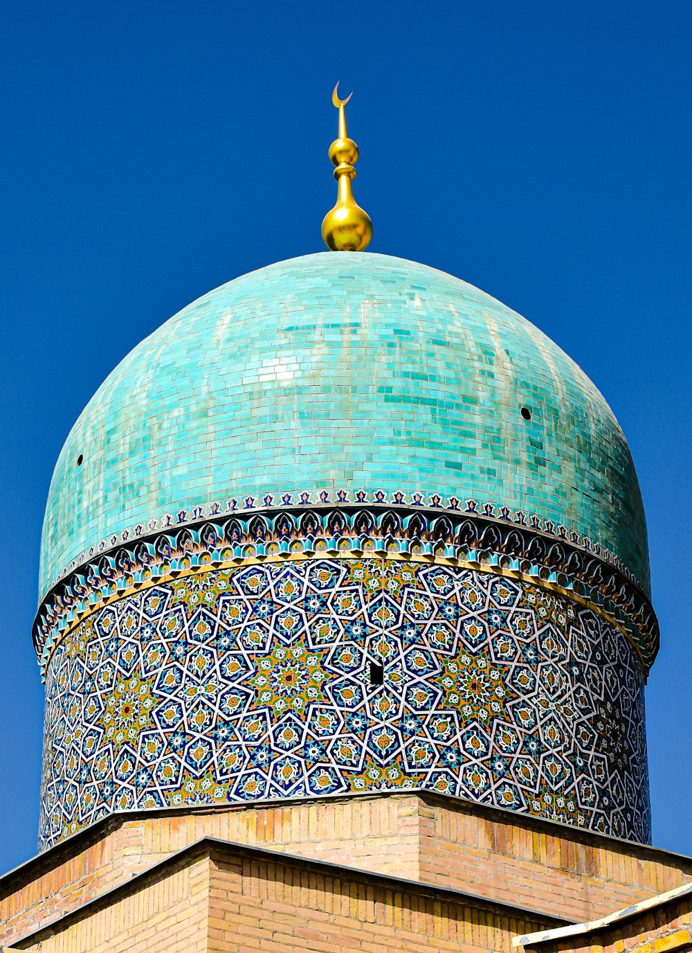 a domed building with a gold statue on top