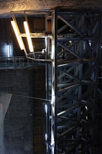 Large industrial pavilion with steel structure and bright lighting.