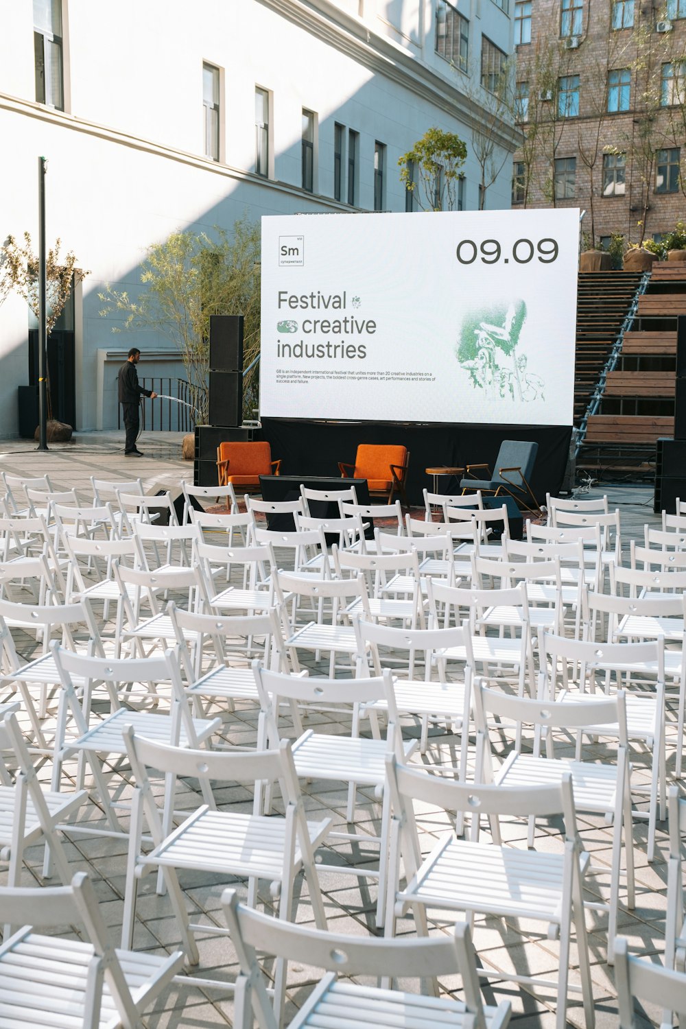 a group of white tables and chairs outside