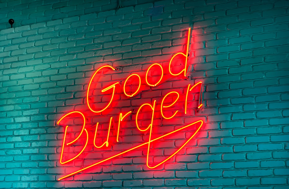 a neon sign on a brick wall