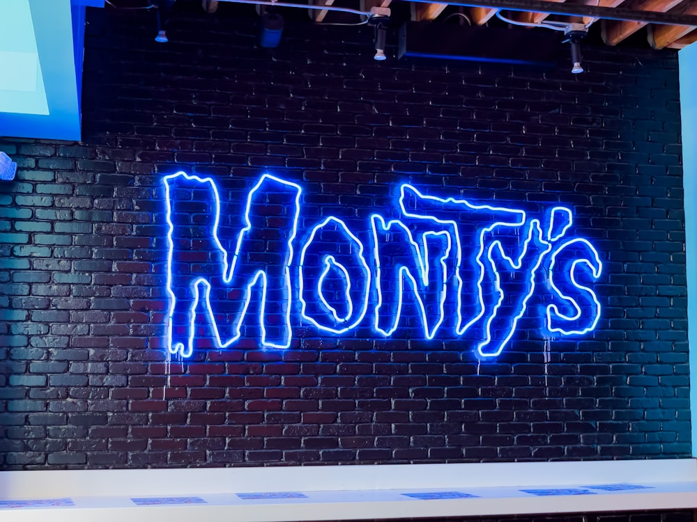 a brick wall with blue writing