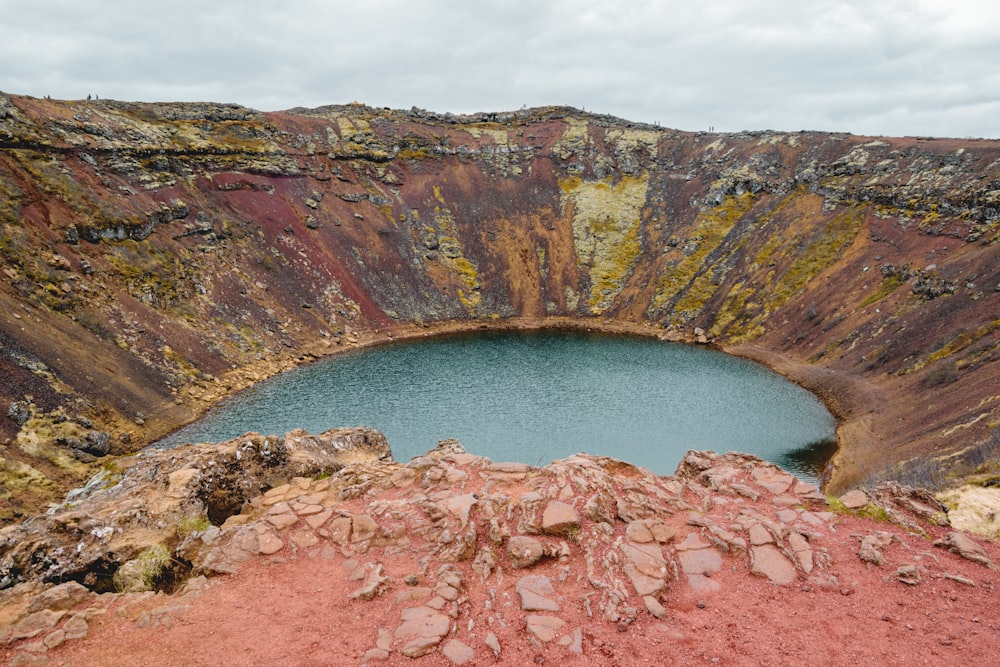 a large canyon with a blue lake