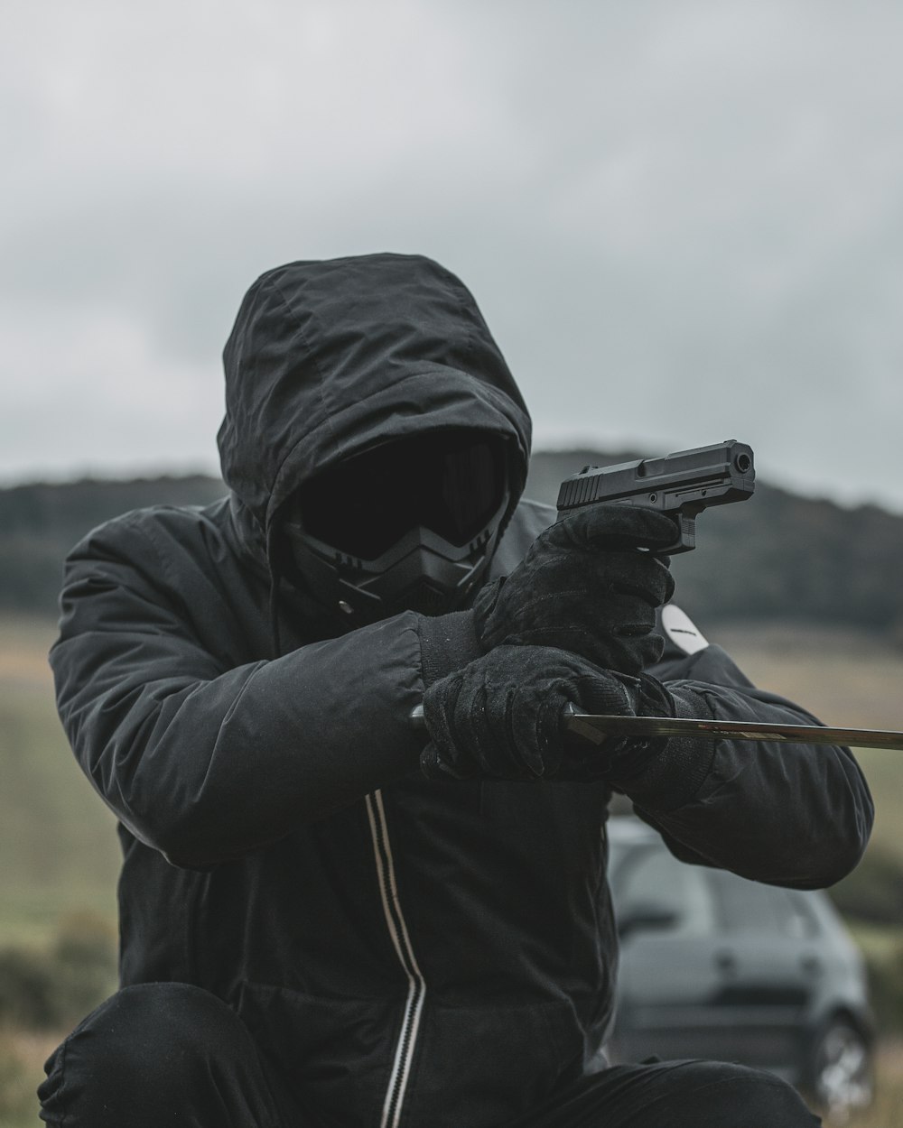 a person wearing a mask and holding a gun