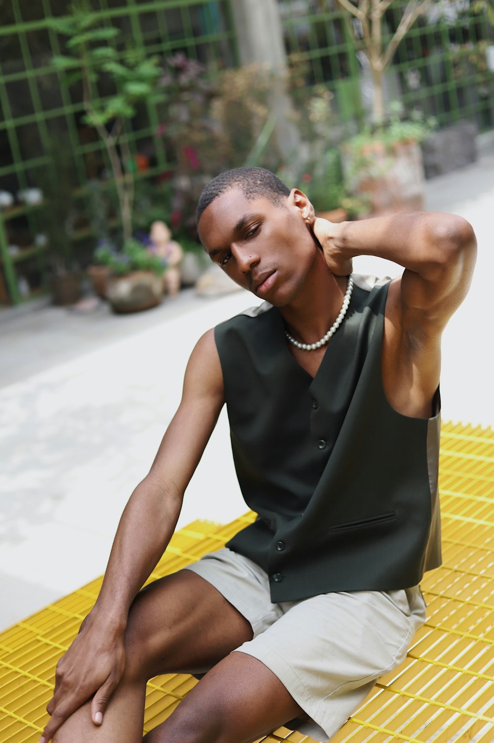 a man sitting on a yellow and white chair