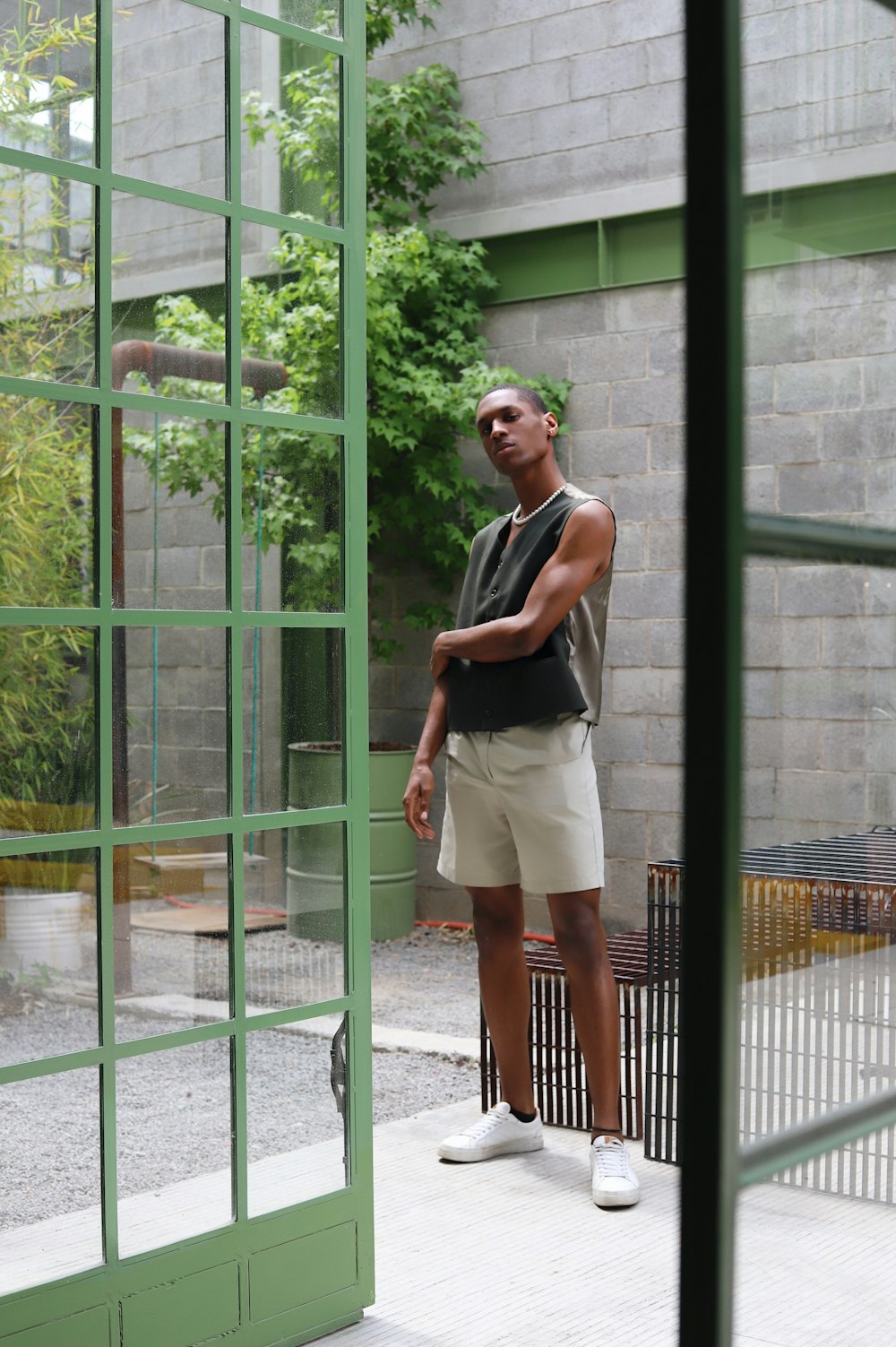 a woman standing in front of a glass wall