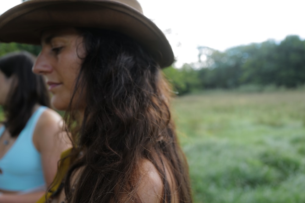 a woman with a hat looking at another woman