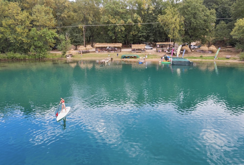 a person on a surfboard in a lake