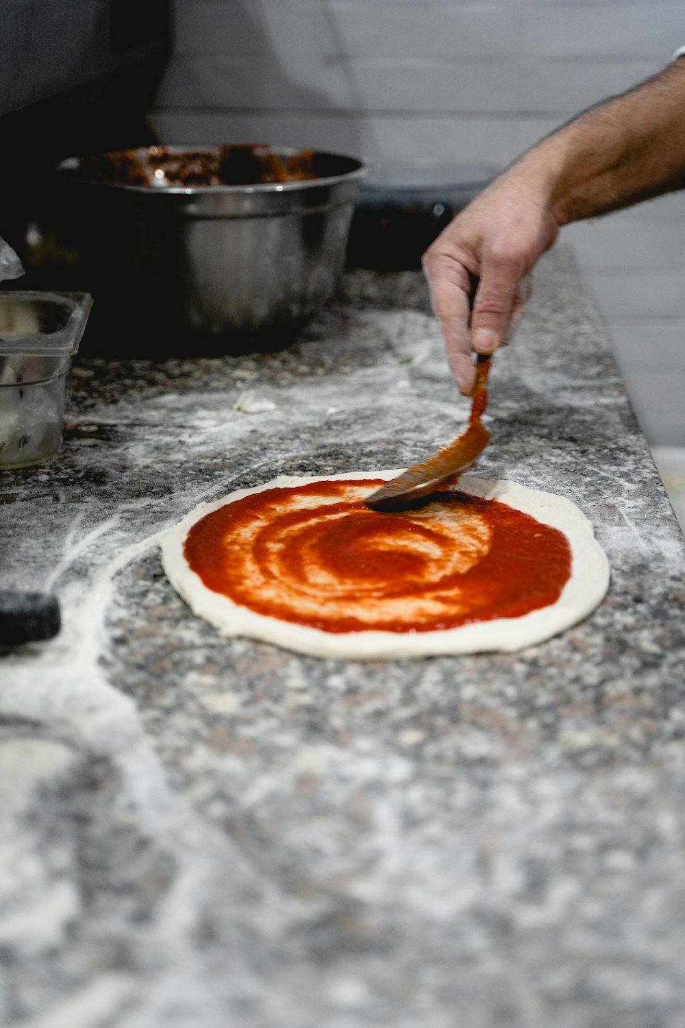 a person slicing a pizza
