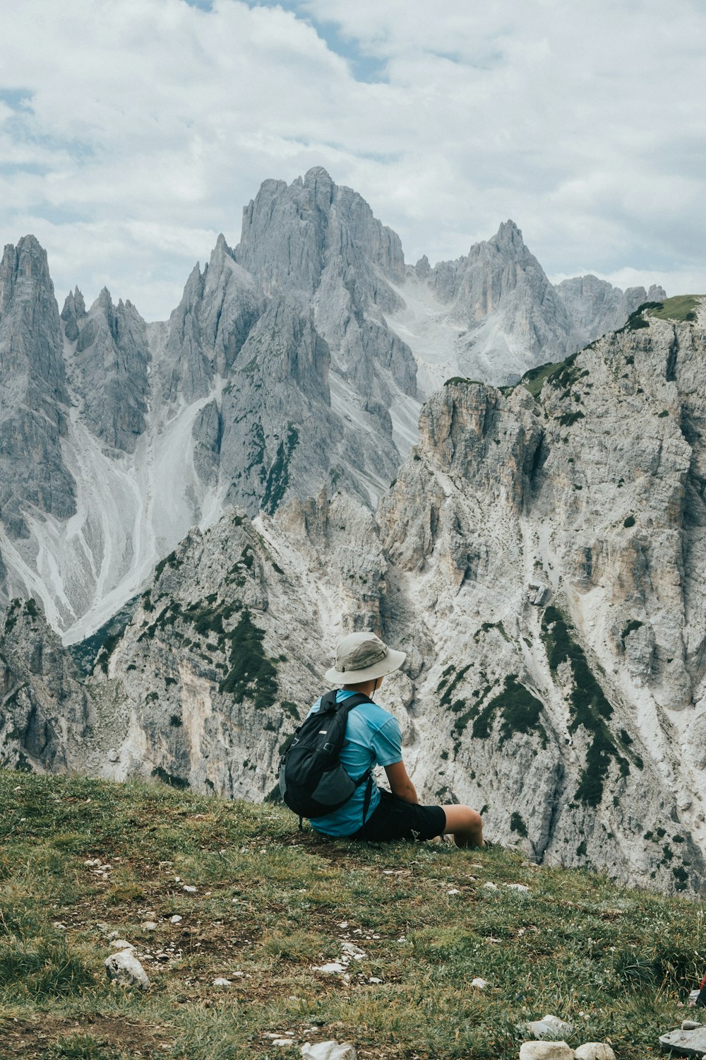 a person sitting on a rocky hill