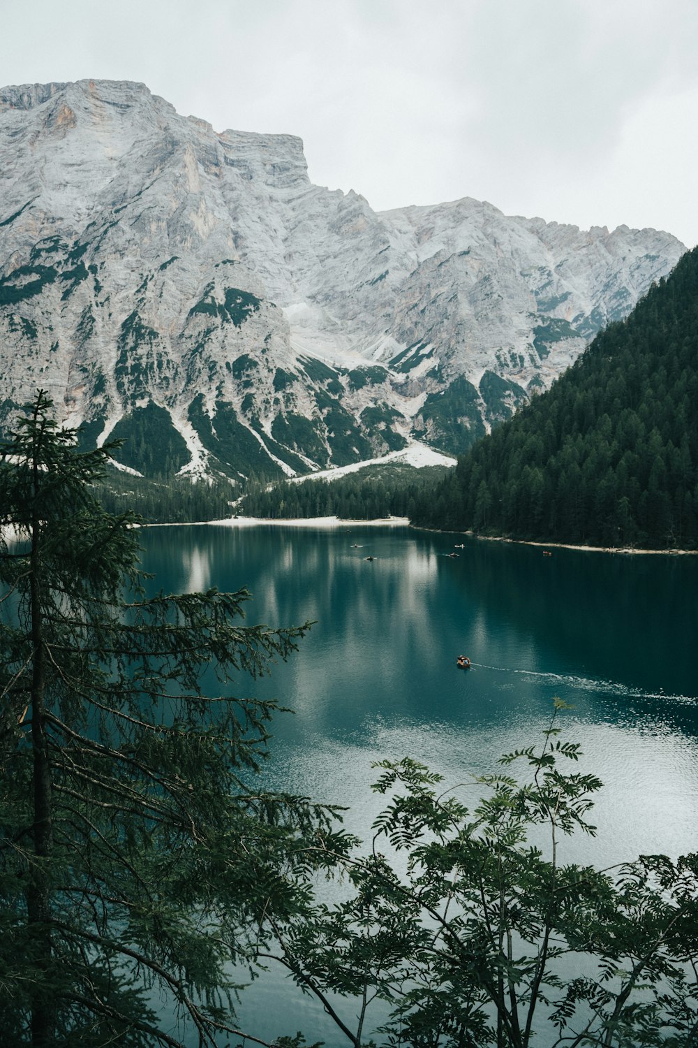 a lake surrounded by snow covered mountains