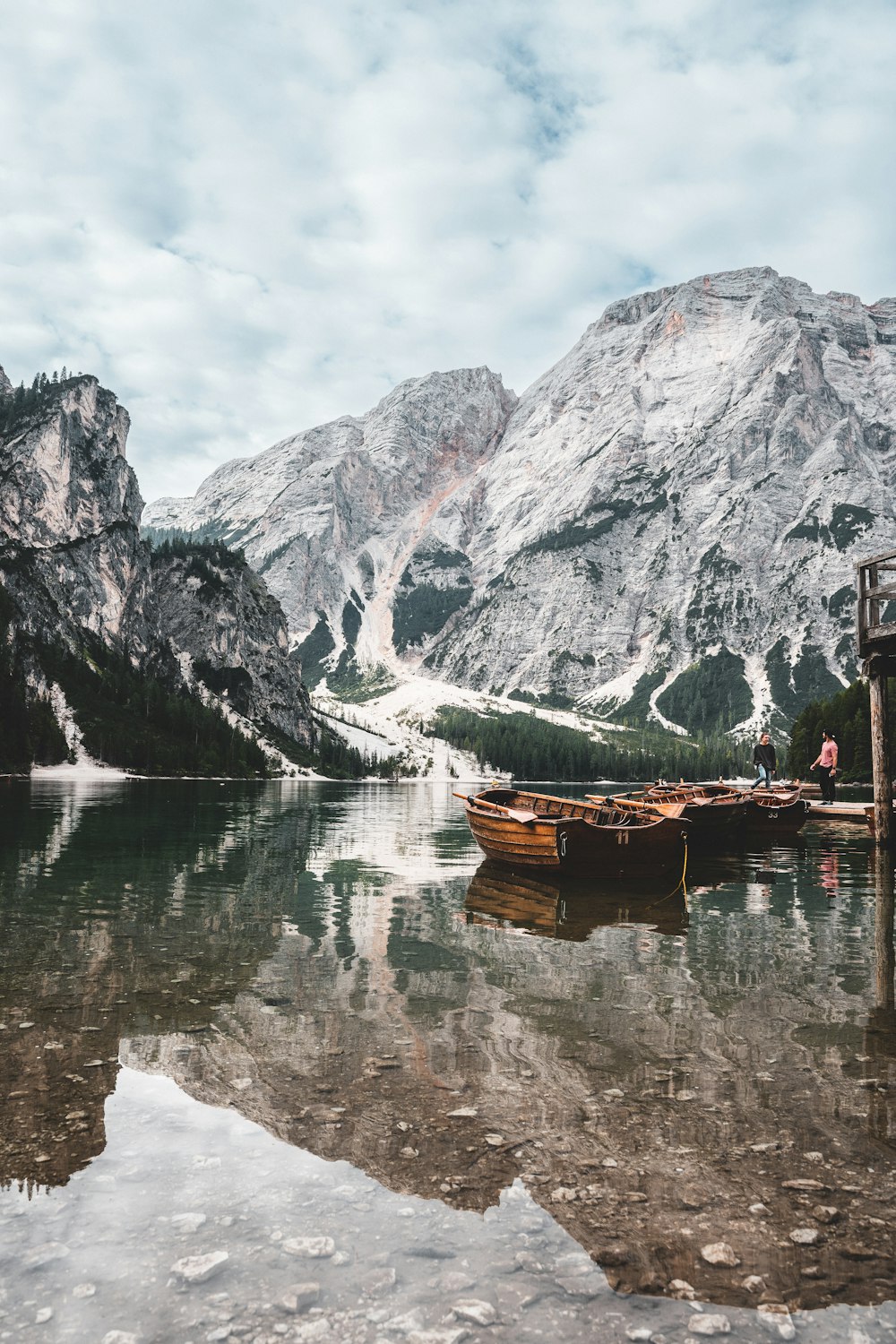 a boat on a lake with snowy mountains in the background