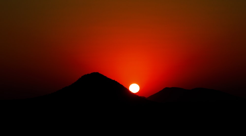 a sunset over a mountain