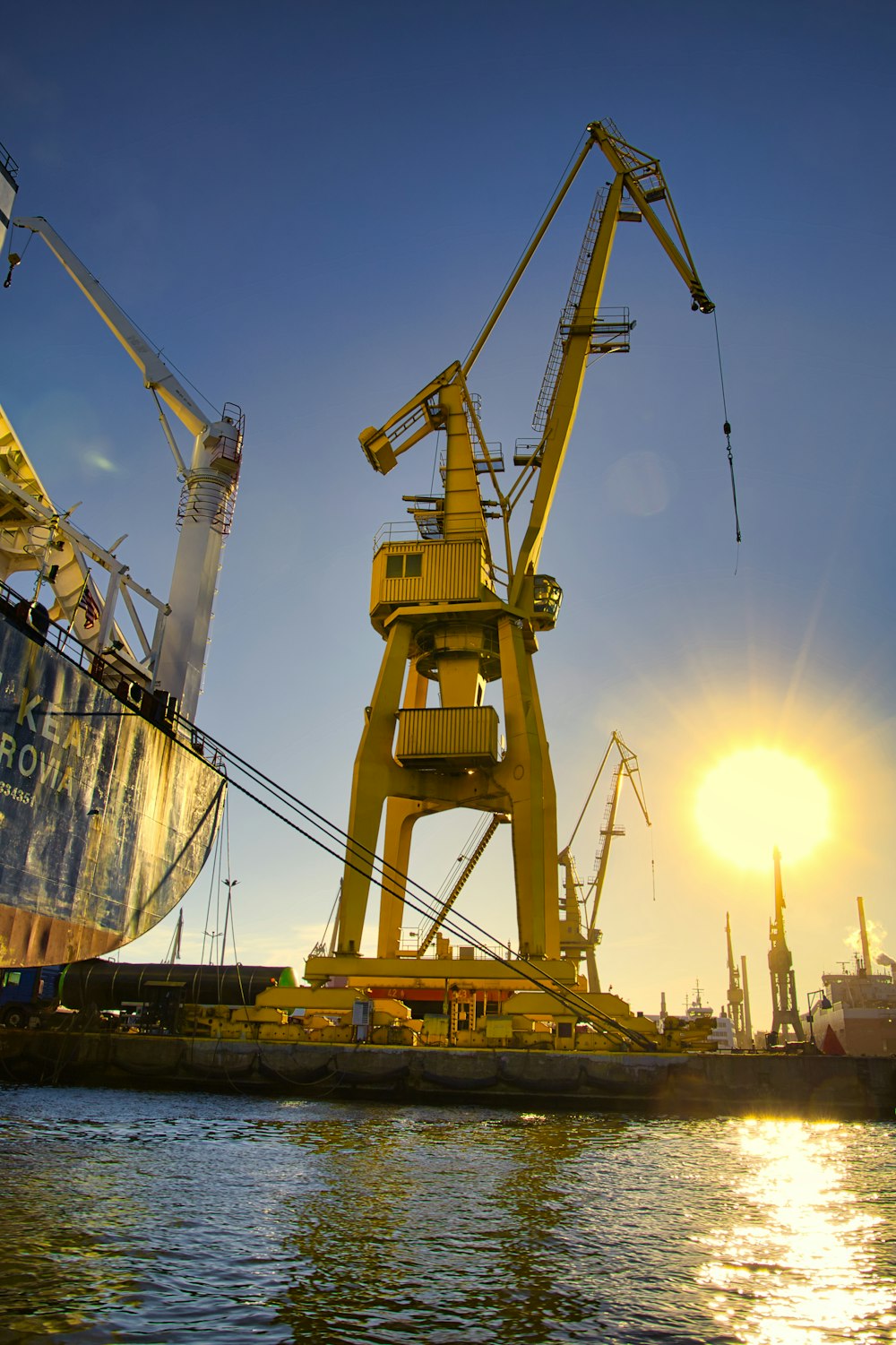 a group of cranes on a dock