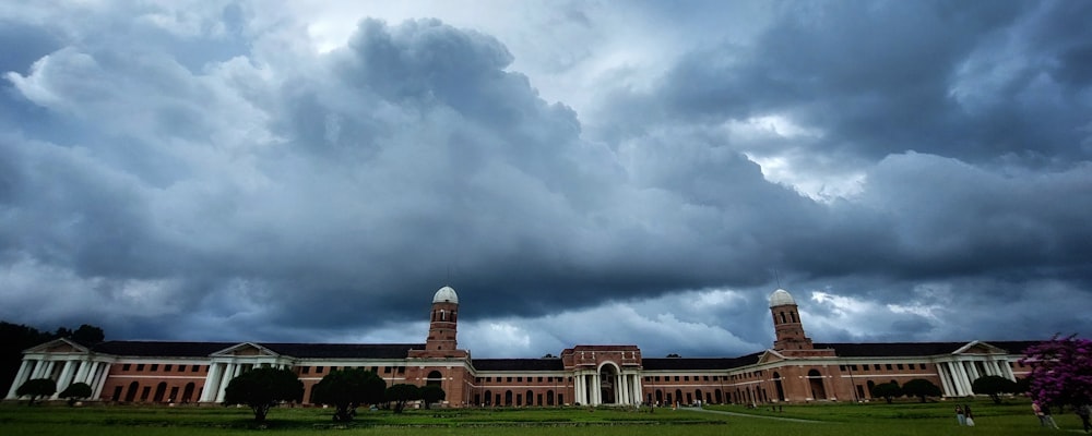 a large building with a green lawn