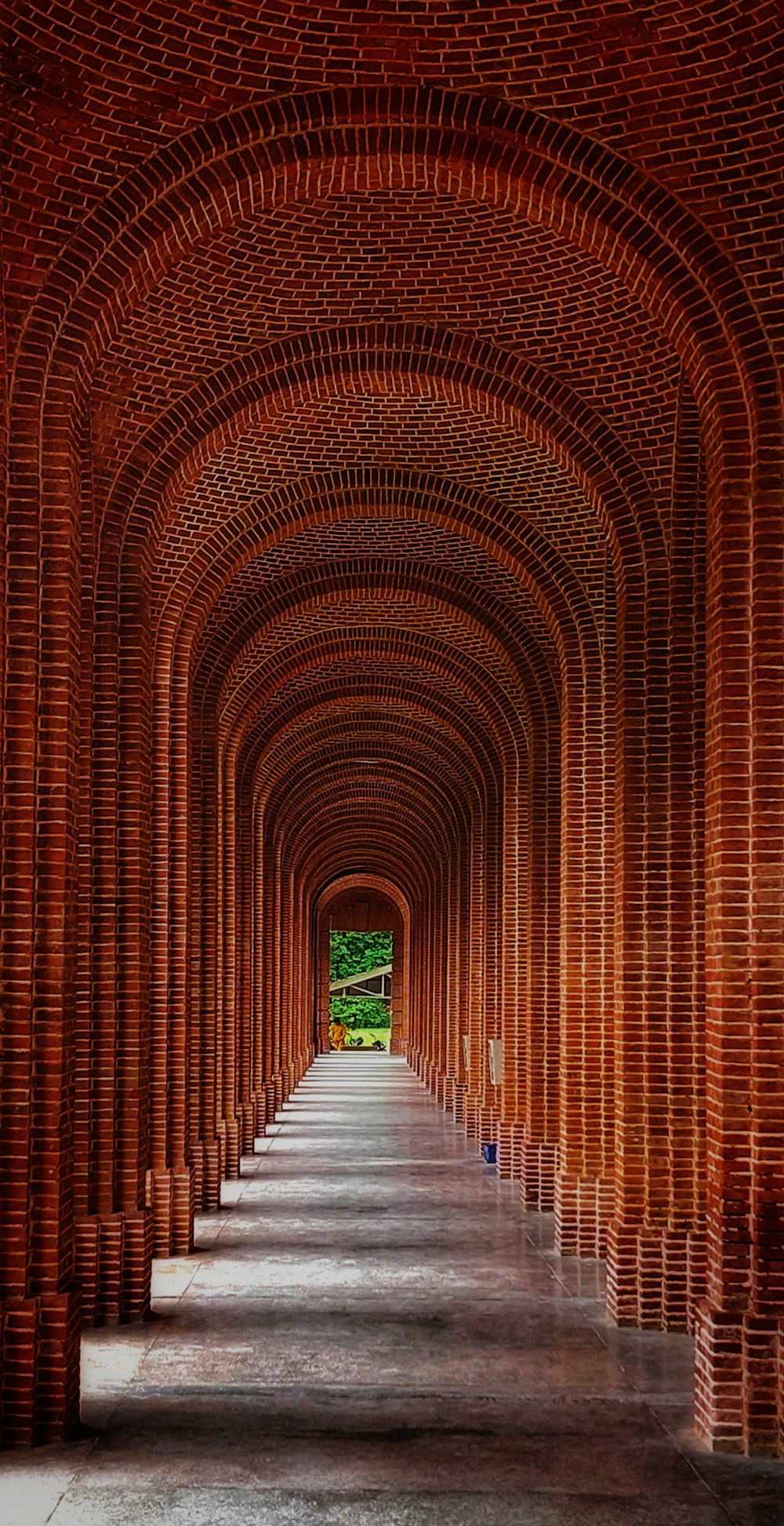 a brick walkway with a brick archway