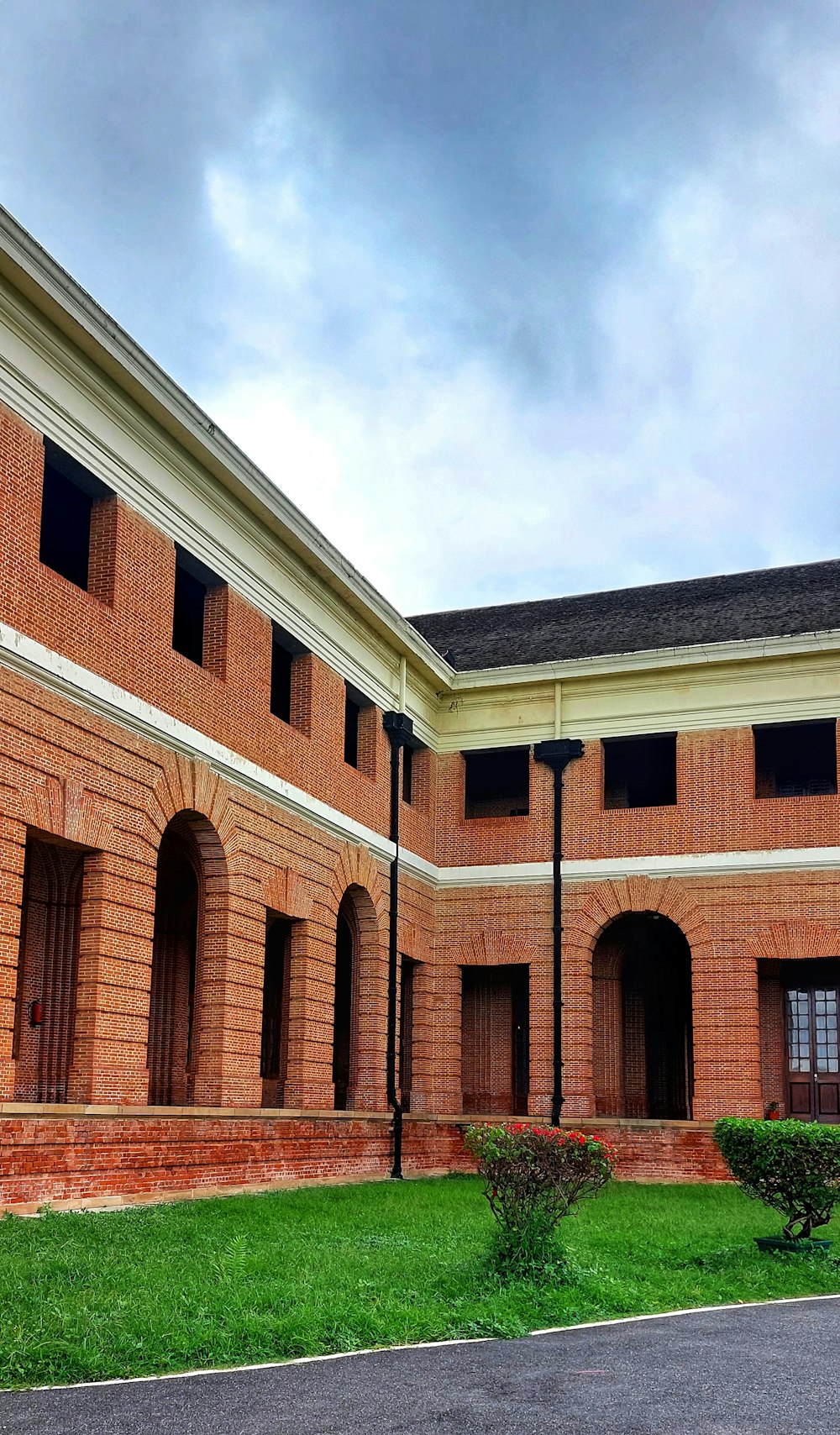 a brick building with a green lawn