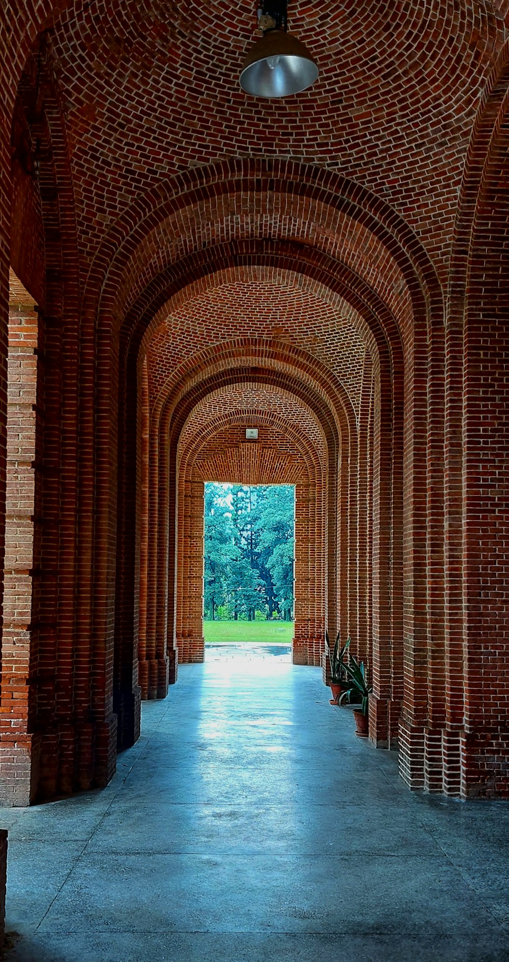 a brick archway with a light
